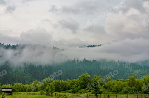 Preview: Beautiful shot of fog over the mountains after the rain
