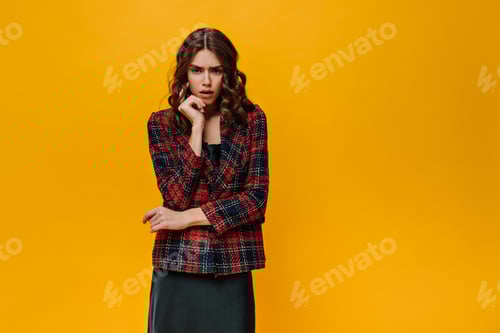 Preview: Girl in striped jacket posing on isolated backdrop.Disappointed brunette woman in red and black clo