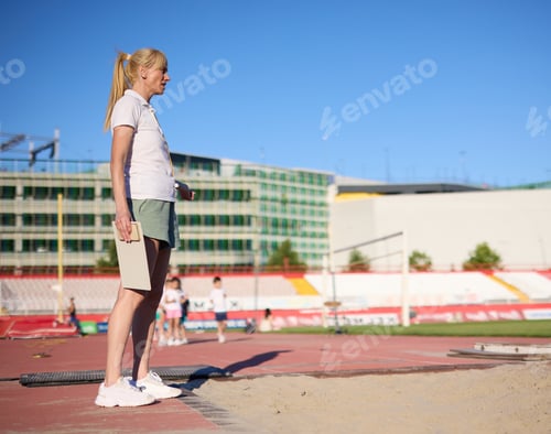 Preview: Children having sport exercise training class outdoors