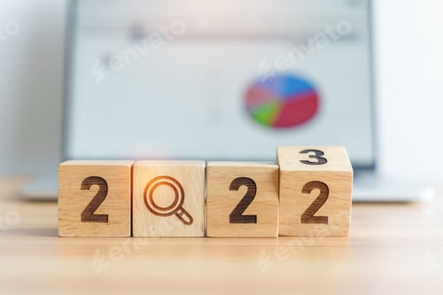 Preview: 2023 block with magnifying glass icon against laptop background. Hi
