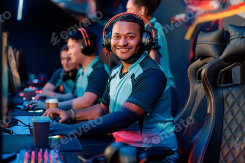 Preview: Cheerful gamer participates in team play in cyber club