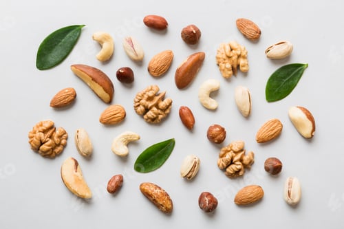Preview: Composition of nuts , flat lay - mix hazelnuts, cashews, almonds on table background.