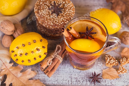 Preview: Autumn hot tea with lemon in glass cup.