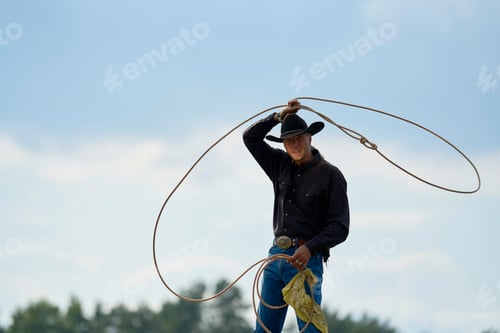 Preview: Cowboy performing a lasso trick under a cloudy sky.