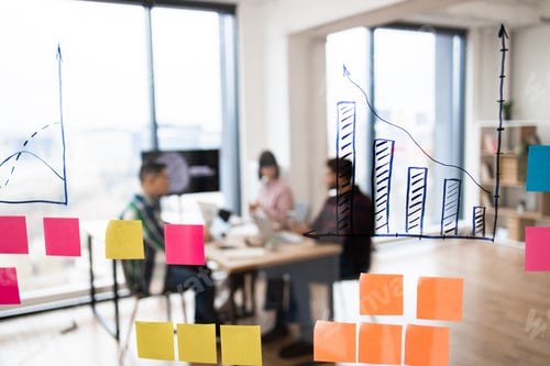 Preview: Business meeting with data analysis on glass board