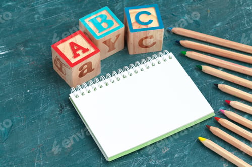 Preview: Notepad on wooden table and wood alphabet blocks
