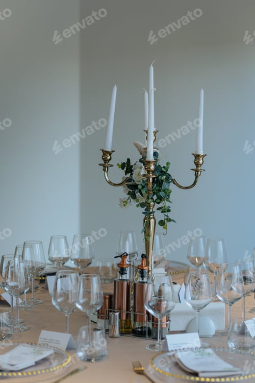 Preview: Elegant dinner table with a candlestick holder, cutlery, glasses on a orange cloth