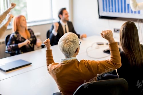 Preview: Young businessman presenting project strategy showing ideas on interactive whiteboard in office