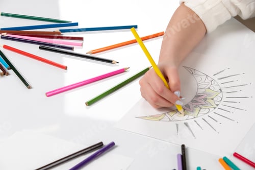 Preview: Drawing a young girl hand drawing a moon with yellow pencil
