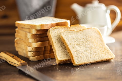 Preview: White sliced toast bread on wooden table.