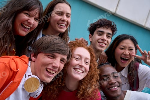 Preview: Selfie of smiling multi-ethnic group of college students together outdoors. Joyful young friends.