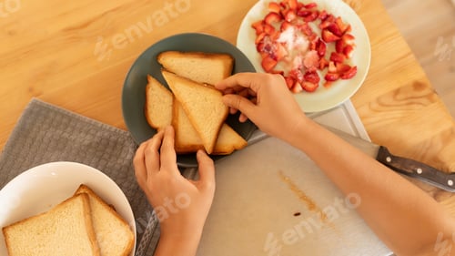 Preview: women's hands make a breakfast of toasted triangles