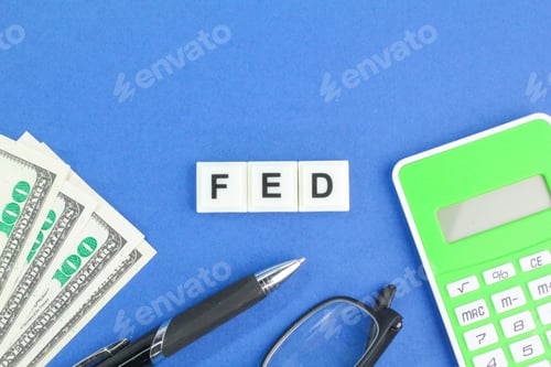 Preview: glasses, paper money, pen and calculator with the letter FED.