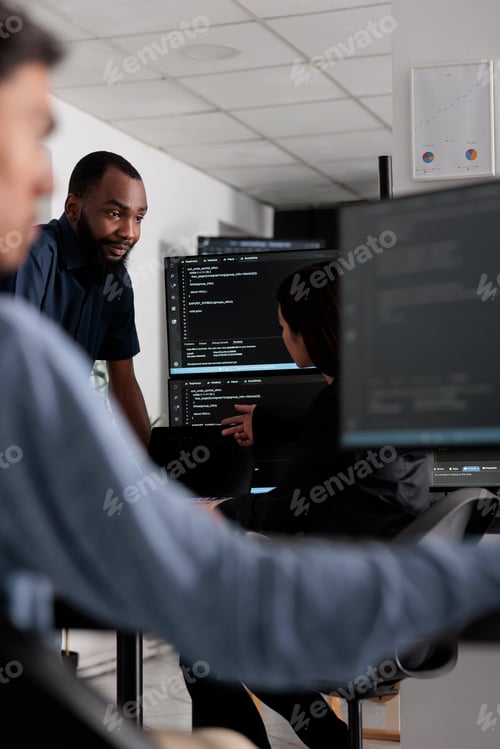 Preview: Multi ethnic team of software developers talking about html code