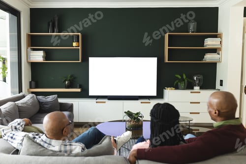 Preview: African american parents, and grandfather watching tv with copy space, slow motion