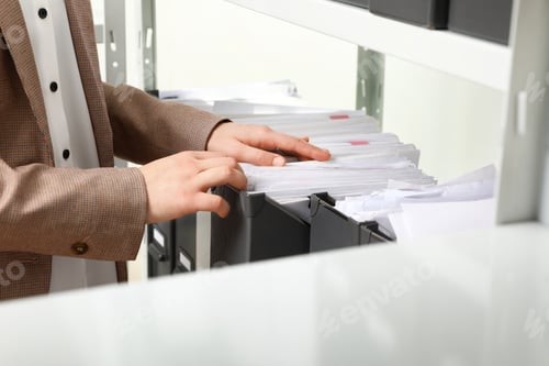 Preview: Woman taking documents from folder in archive, closeup