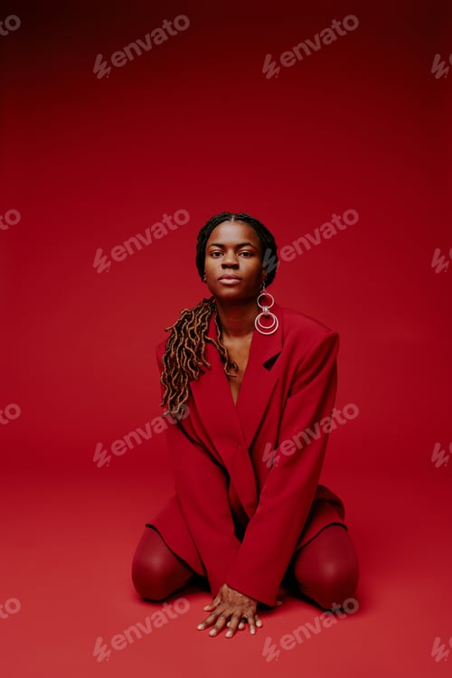 Preview: Portrait of Confident Woman Kneeling in Red Attire