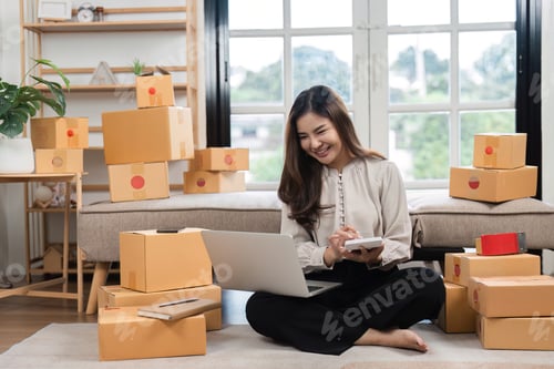 Preview: Smiling Woman Calculating Finances at Home Workplace