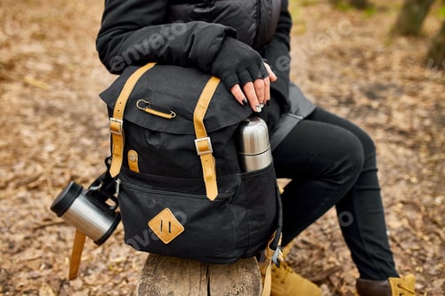 Preview: Unrecognizable woman backpacker traveler sitting on bench, travel accessory, relaxing