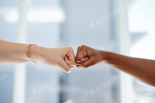 Preview: Cropped shot of two unrecognizable businesswomen fist bumping each other inside an office