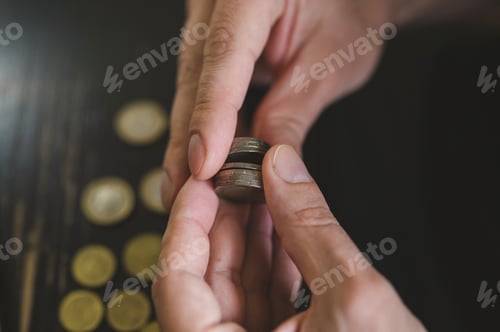 Preview: business man counting money. male hands holds and count coins of different euros on table