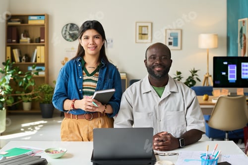 Preview: Portrait of Asian Woman and Black Man Collaborating at Desk