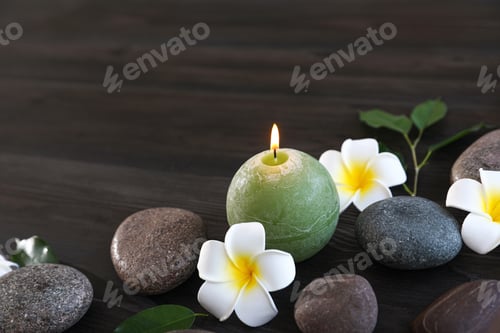 Preview: Composition with spa stones, flowers and candle on wooden background. Space for text