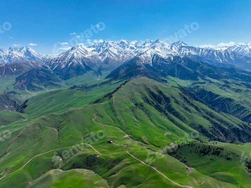 Preview: Majestic Green Foothills and Snow-Capped Mountains Panorama