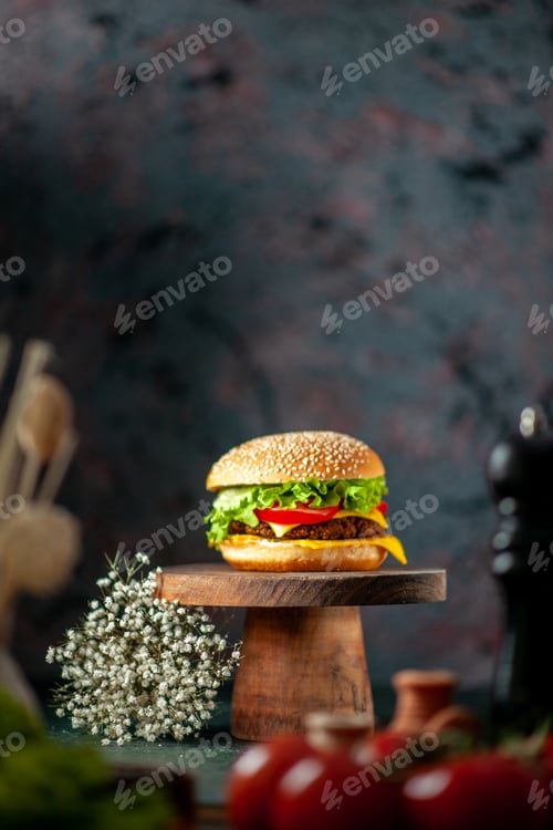 Preview: front view tasty meat hamburger with knife tomatoes and pepper shaker on dark background fast-food