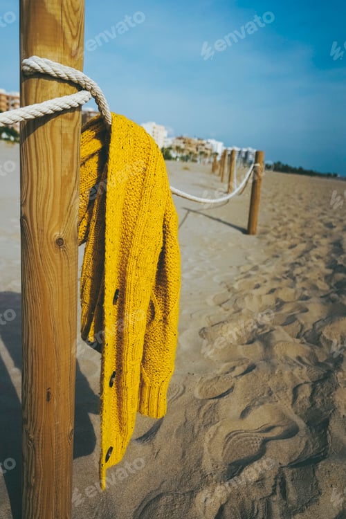Preview: Moody scene of an abandoned woolen coat in the mediterranean coast
