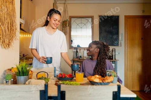 Preview: Roommates sharing breakfast and conversation at home