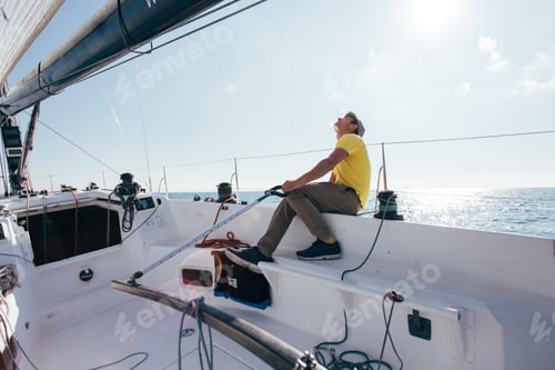 Preview: Captain or sailor of sailboat steers yacht in wind