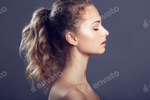 Preview: Sowing off her lovely locks. An attractive young woman with her eyes closed in studio.