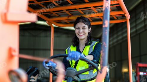 Preview: women worker at forklift driver happy working in industry factory logistic ship.