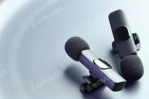 Preview: Lavalier microphones on light grey background, closeup. Space for text
