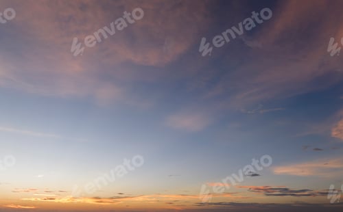 Preview: Colorful sunset sky with setting sun behind vivid orange and yellow clouds