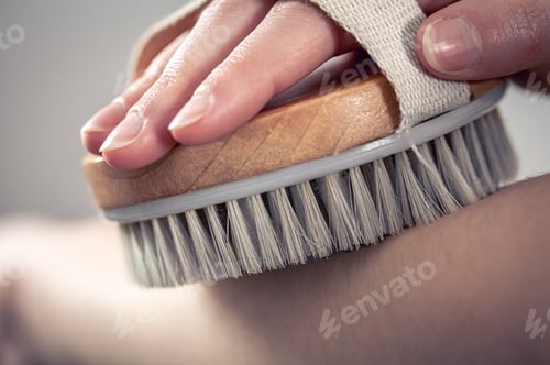 Preview: Female hands massage with a massage brush.