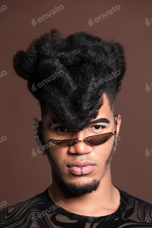 Preview: Young stylish model posing with trendy hairstyle and sunglasses