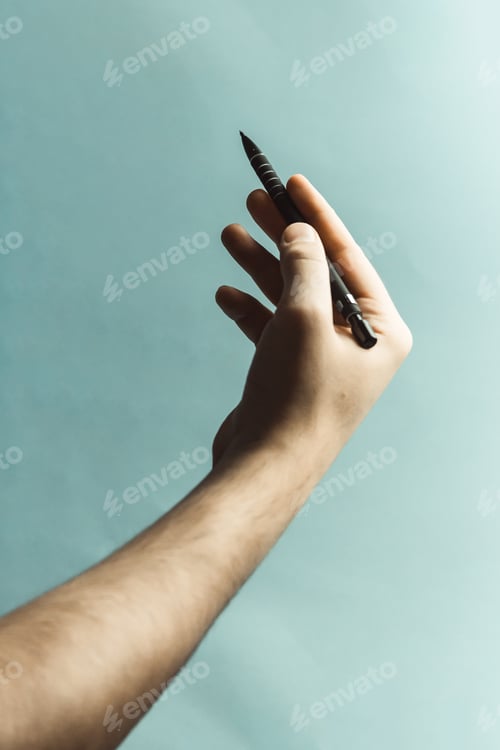 Preview: A young hand grabbing a mechanical pencil over a pastel blue background with deep shadows