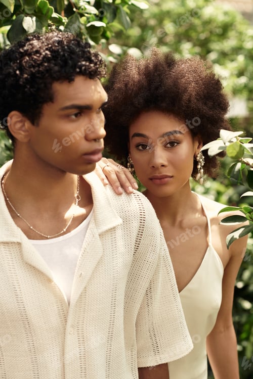 Preview: Young couple sharing a moment of love and connection in a lush greenhouse filled with greenery