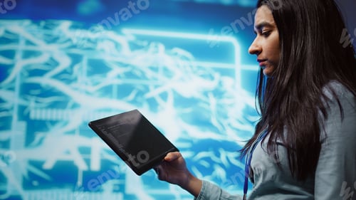 Preview: Close up shot of computer scientist using tablet in AI company workspace