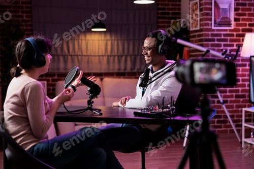 Preview: Man and woman recording podcast conversation on camera