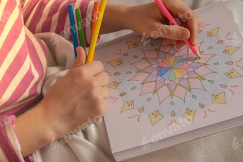 Preview: Female painting mandalas antistress page to combat stress. Relaxing hobby mental wellbeing and art