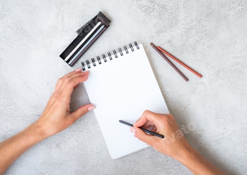 Preview: Girl's hands drawing in notebook