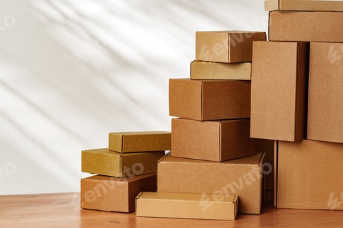 Preview: Stacked Cardboard Boxes On Wooden Surface In Sunlight