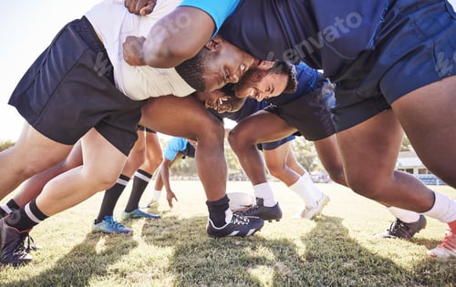 Preview: Below two opponent rugby teams contesting a scrum during a match outside on a field. Rugby players