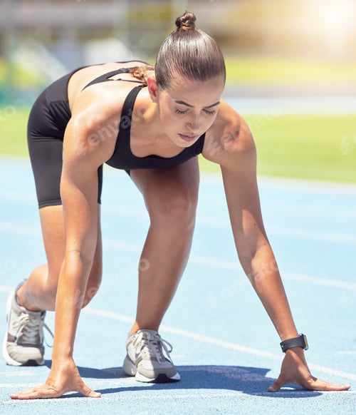 Preview: Runner, woman and focus of a athlete about to start a run on a sport track outdoor. Fitness, sports