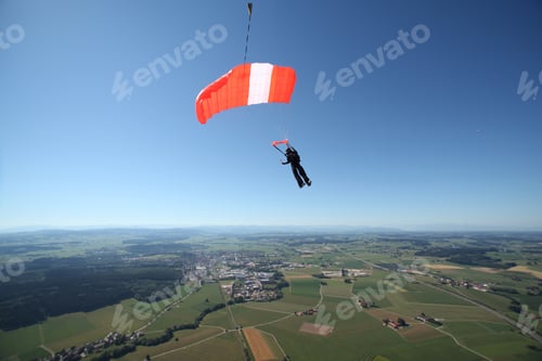 Preview: Skydiver parachuting down above Leutkirch, Bavaria, Germany