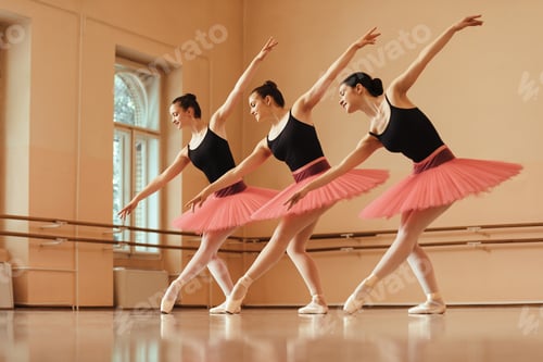 Preview: Below view of smiling ballerinas dancing at ballet studio.