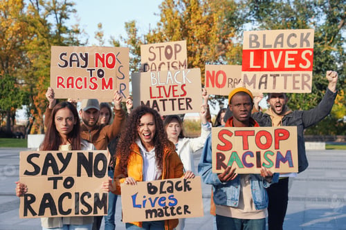 Preview: Protesters demonstrating different anti racism slogans outdoors. People holding signs with phrases